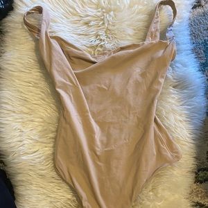 Skims body suit says xs but will fit a small.